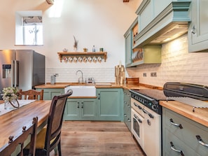 A kitchen with a wooden countertop, a sink, a stove, and a refrigerator. - 4 bedroom accommodation in Dorrington, near Lincoln (Dorrington, near Lincoln)