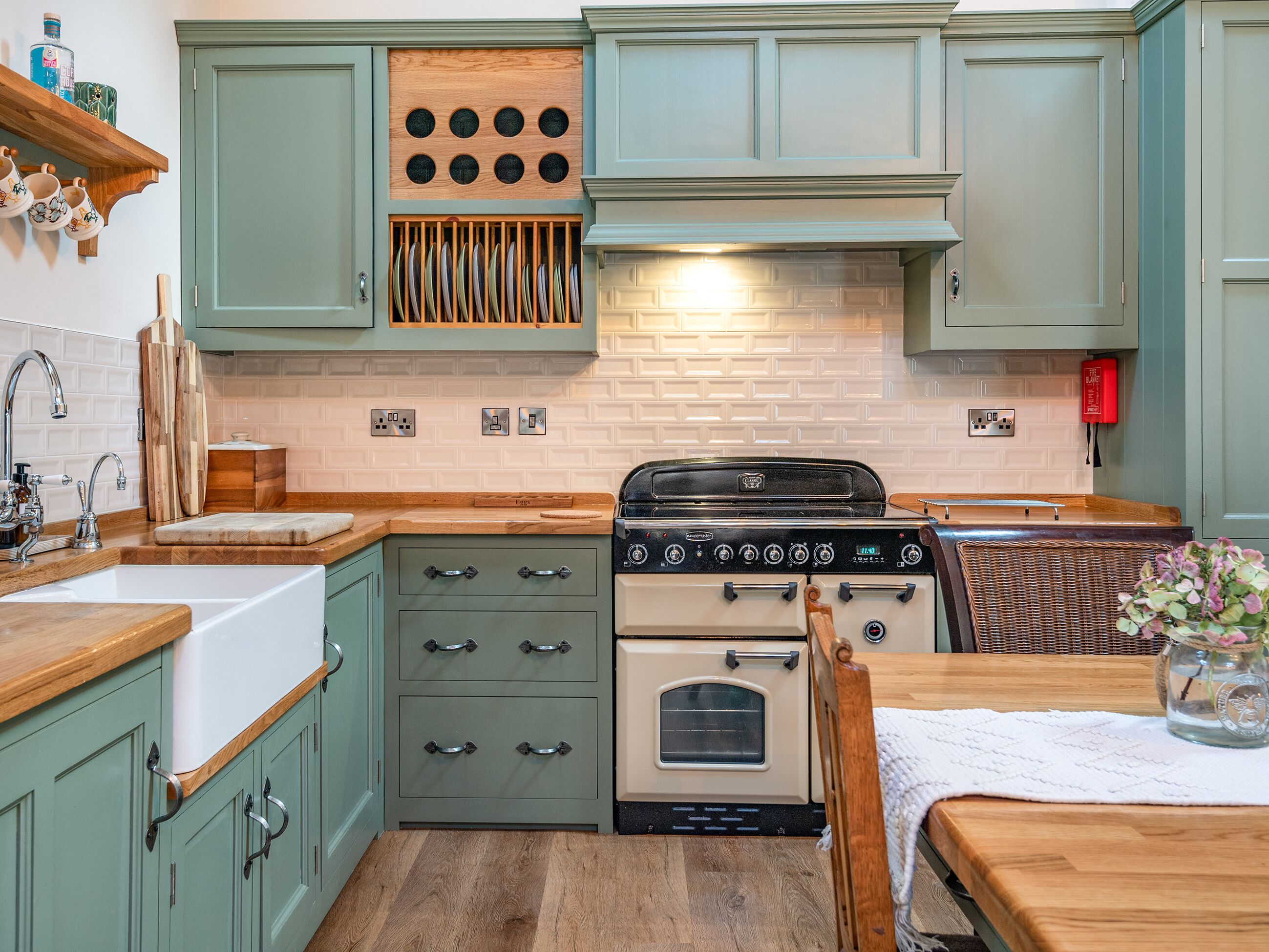 A kitchen with a stove, oven, and wooden cabinets.