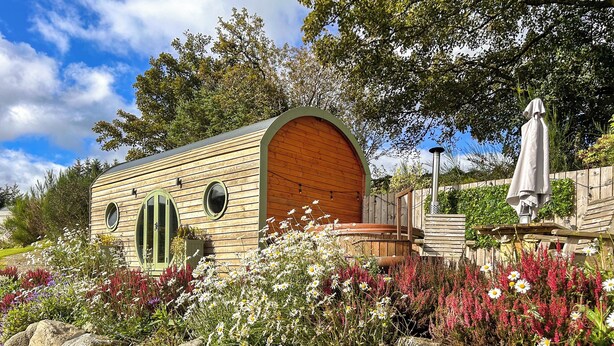 A wooden cabin with a curved roof, two windows, and a small porch. - A hidden gem in the stunning Ayrshire countryside. (Straiton, near Maybole)