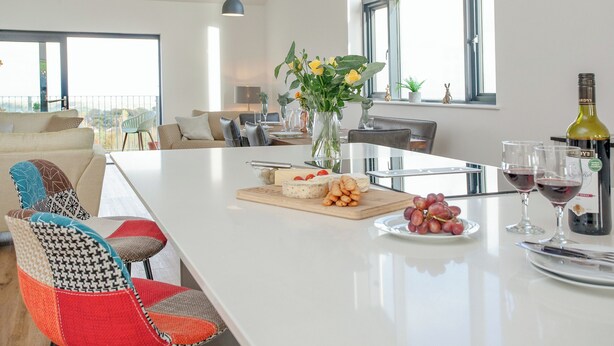 A modern kitchen with a central island, dining area, and large windows. - 3 bedroom accommodation in Over Stowey, near Bridgwater (Over Stowey, near Bridgwater)