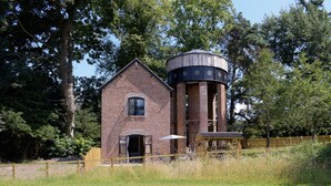 A brick building with a water tower.