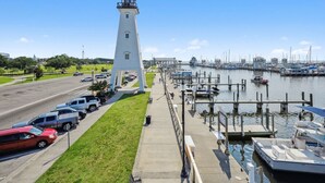 A lighthouse, marina, and parked cars. - Beachside Gem! Walk to the Beach! Close to Shopping, Dining, & More! (Gulfport)