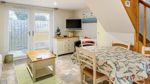 A cozy room with a bed, a desk, a chair, a television, and a staircase. - 1 bedroom accommodation in Osmotherley (Osmotherley)