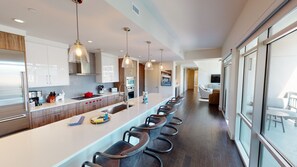 Enjoy casual dining and socializing in this well-lit kitchen with an oven and microwave.
