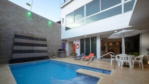 A modern outdoor pool area with a hot tub, lounge chairs, and a patio with tables and chairs. - LUXURY HOUSE, CLOSE TO THE BEACH (Manzanillo del Mar)