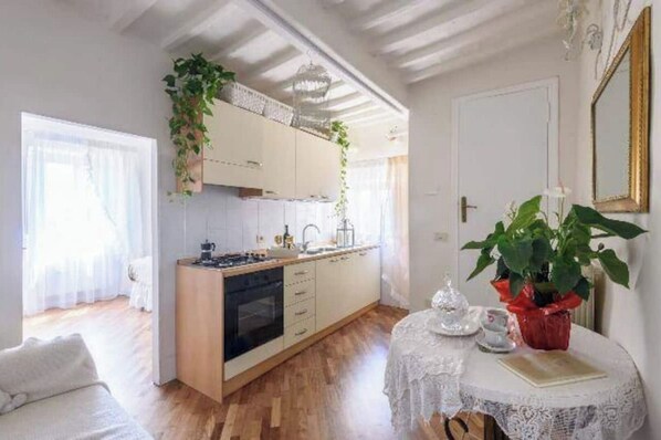 Enjoy meals in this kitchen with a dining table and potted plant.