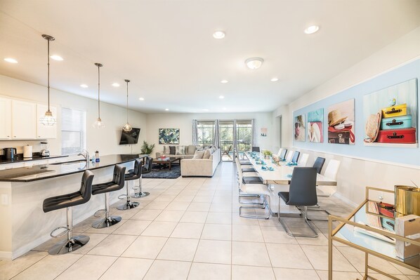 Enjoy meals with friends and family at the dining table, flanked by comfortable bar stools.