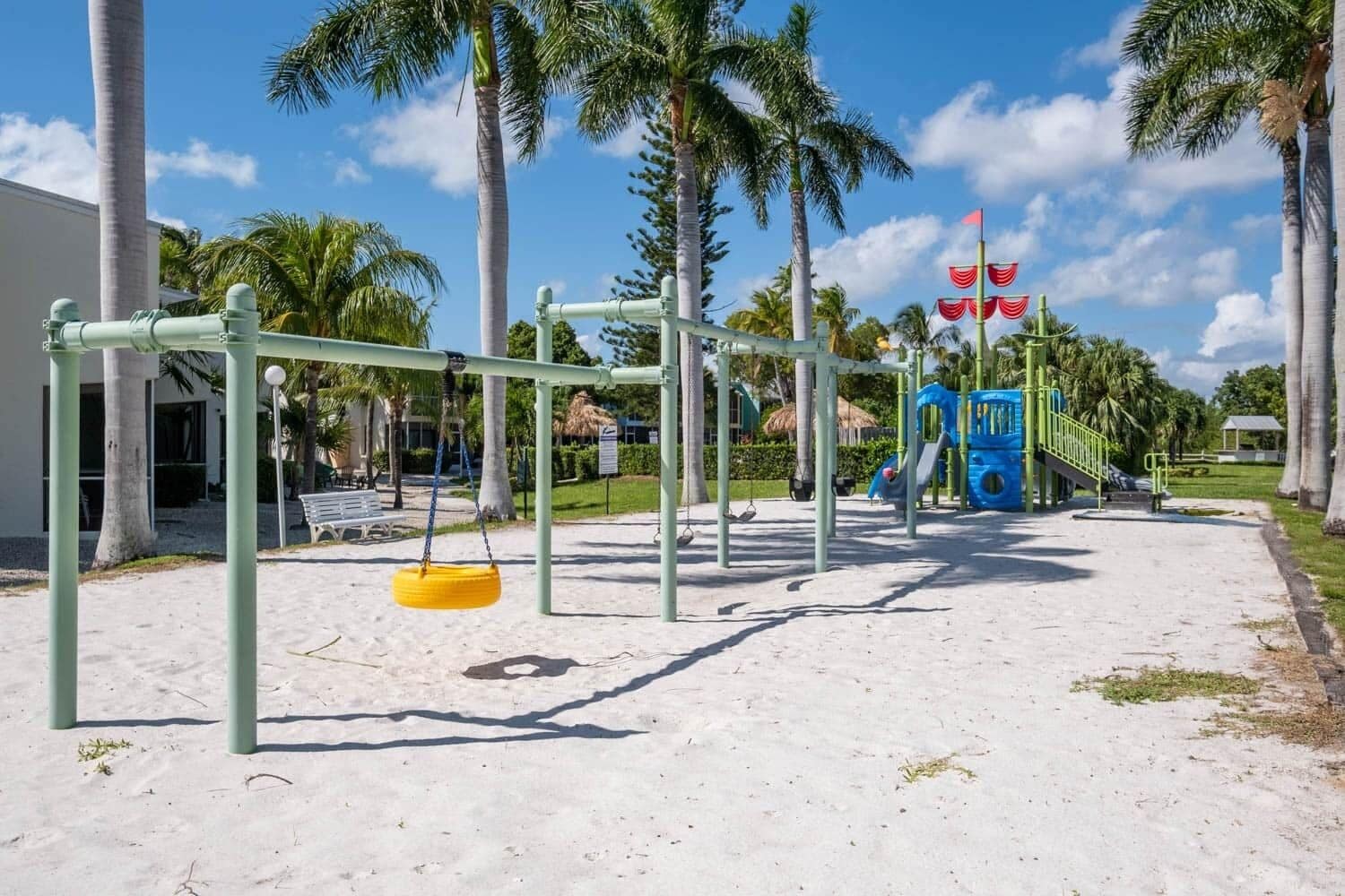 A playground with swings, a slide, and a climbing structure.