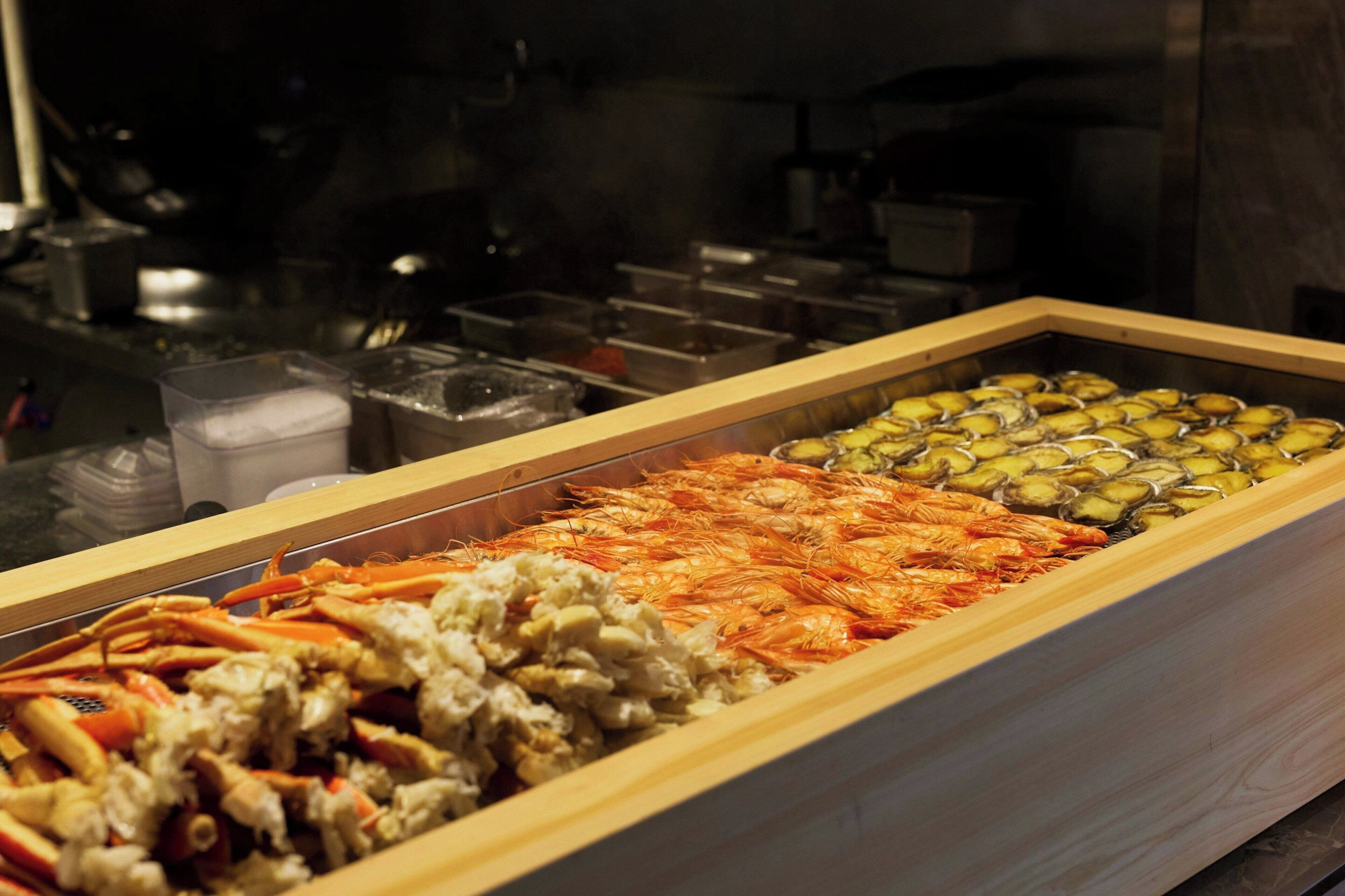 A seafood display case with various types of shellfish.
