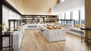 A spacious, modern kitchen with marble countertops, stainless steel appliances, and large windows offering views of the city. - Hotel Onoma Daejeon, Autograph Collection (Daejeon)
