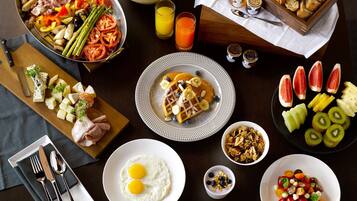 A breakfast spread with various foods and drinks.