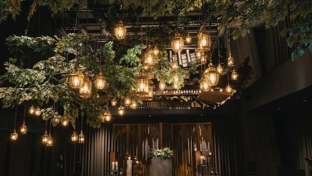 A banquet hall with hanging lanterns, a long table, and a central floral arrangement. - Hotel Onoma Daejeon, Autograph Collection (Daejeon)