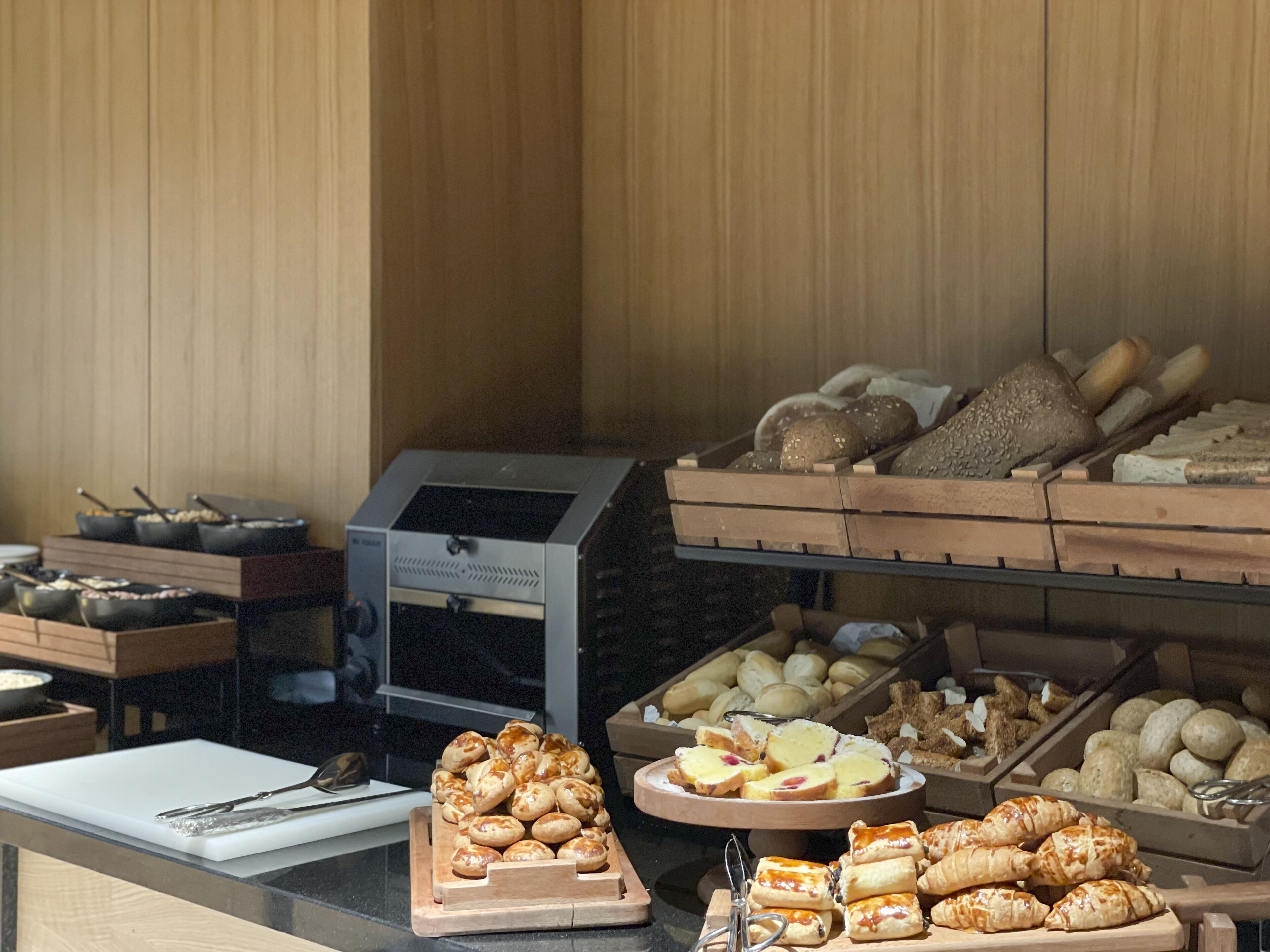 A buffet with various baked goods and pastries.