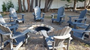 A circular arrangement of Adirondack chairs around a fire pit. - 6 Bed 6 bath Country Red Brick Home (Eden)