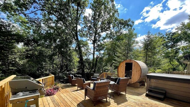 A wooden deck with outdoor furniture, a barbecue grill, and a barrel structure. - Updated in 2021 Notre Dame Football Weekend Entertaining Home (South Bend)