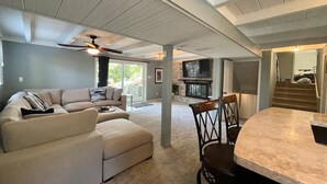 A spacious living area with a sofa, chairs, a fireplace, and a ceiling fan. - Updated in 2021 Notre Dame Football Weekend Entertaining Home (South Bend)