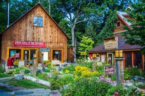 A rustic wooden building with a sign reading "Great Hall of the Republic."