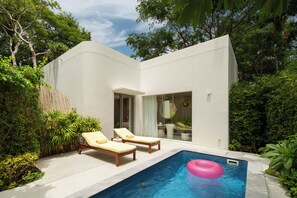 A modern house with a swimming pool, two lounge chairs, and lush greenery. - The Standard Hua Hin (Hua Hin)