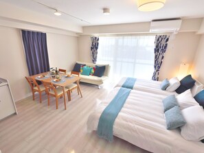 A hotel room with a dining area, a sofa, and a bed. - Kicon Hotels Fuchsia (Nagoya)