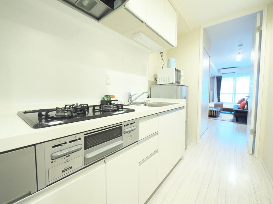 A modern kitchen with a gas stove, microwave, and built-in oven.