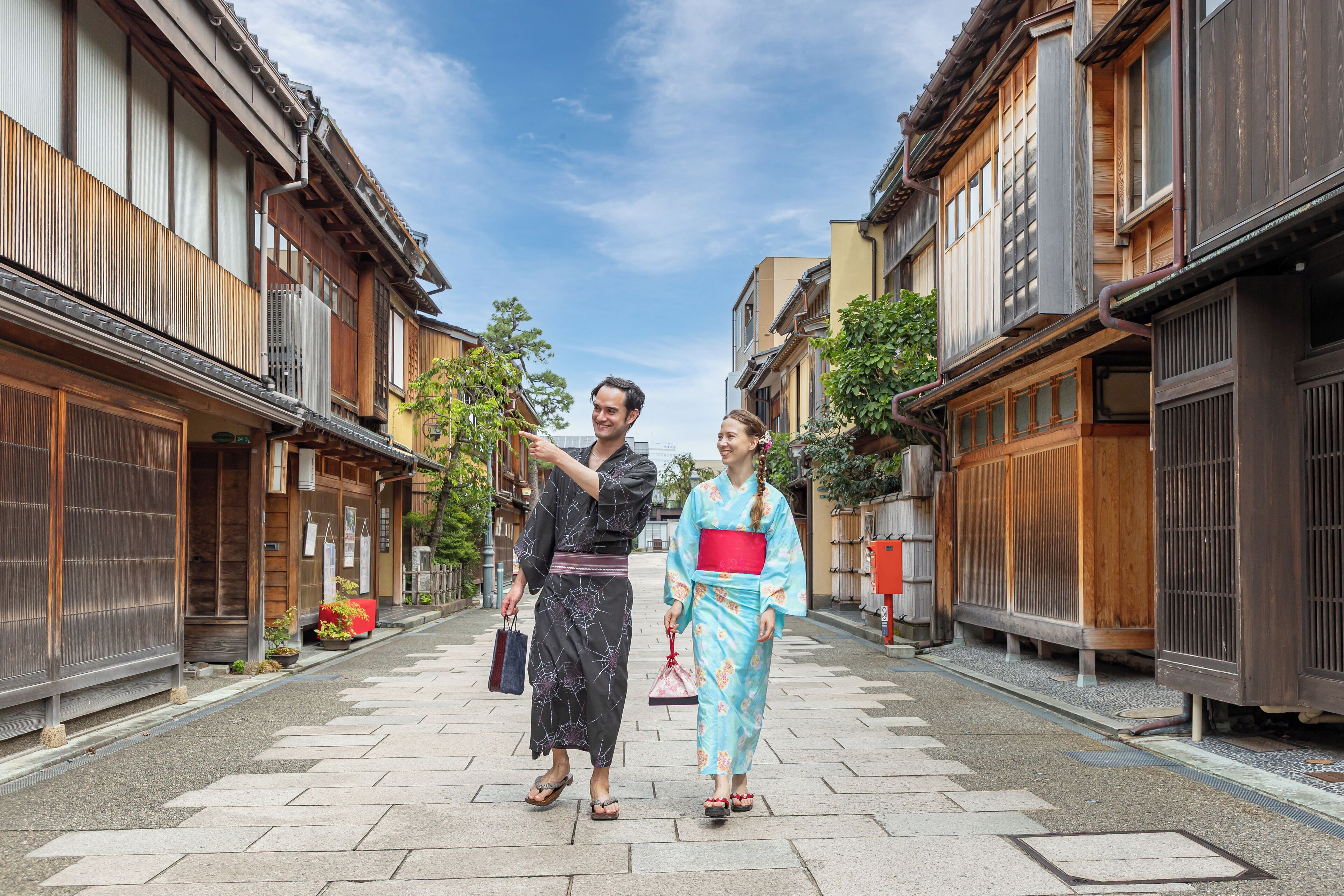A traditional Japanese street with wooden buildings and a clear sky.