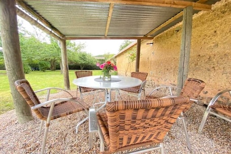 Outdoor dining. Cosy house with large garden