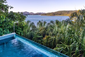 A swimming pool with a view of a lake and mountains. - North Cape 5, North Cape 5 on Hamilton Island (Hamilton Island)