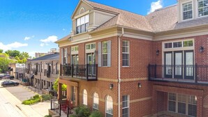 A row of townhouses with brick facades, multiple stories, and balconies. - Game Day Getaway - 1 Block to Dickson-Walk to UofA (Fayetteville)