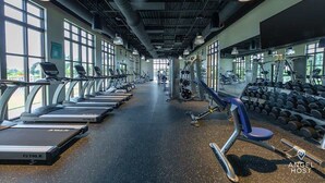 A gym with treadmills, weight machines, and dumbbells. - Private Pool Townhome Near Disney Parks (Kissimmee)