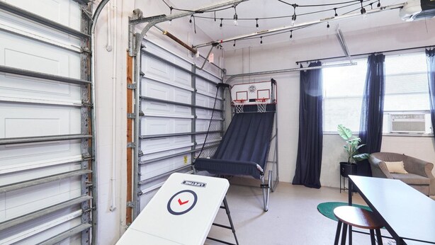 A compact room with a bunk bed, a desk, a chair, and a small table. - The Oasis Retreat +Pool +Game Room +Basketball + Massive Yard +Near Beach & Golf (Largo)