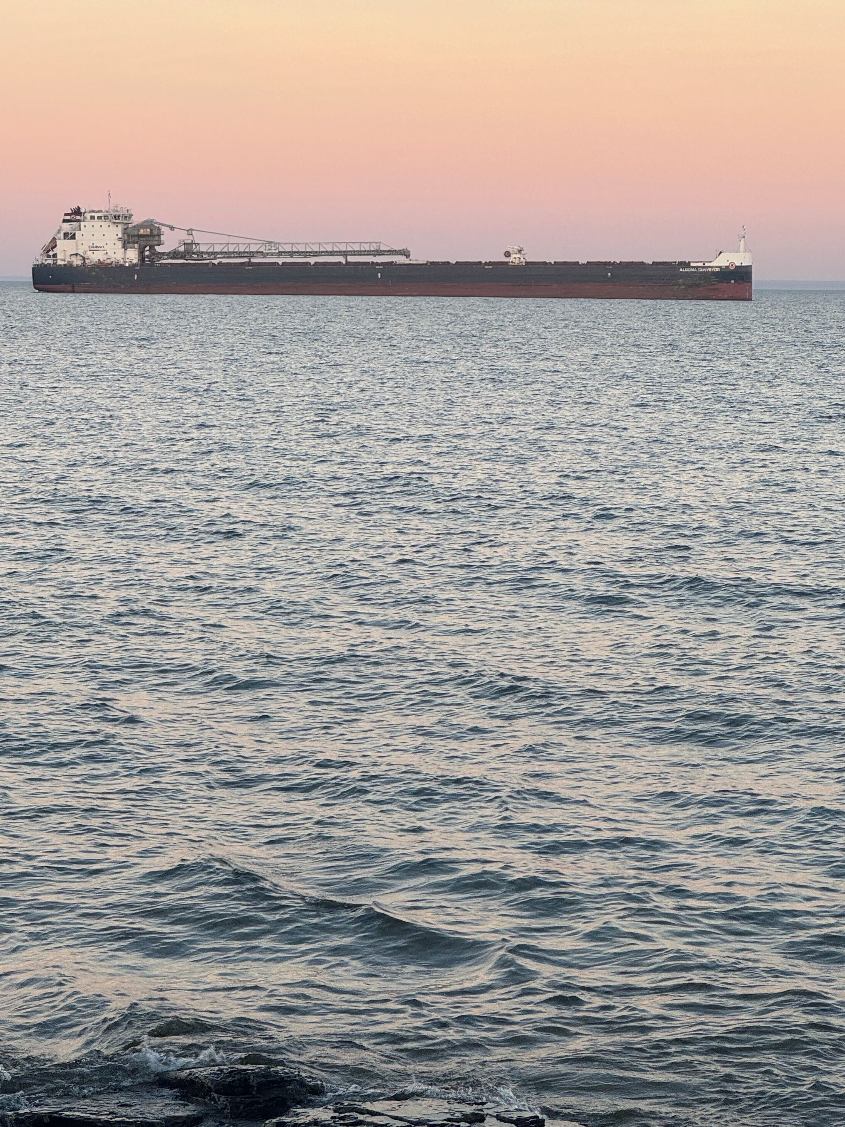 A large cargo ship on calm waters.