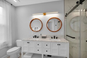 Bathtub, hair dryer, towels, shampoo