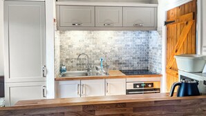 A kitchen with a wooden countertop, a sink, a stove, and cabinets. - 1 bedroom accommodation in Gillamoor, near Kikbymoorside (Gillamoor, near Kikbymoorside)
