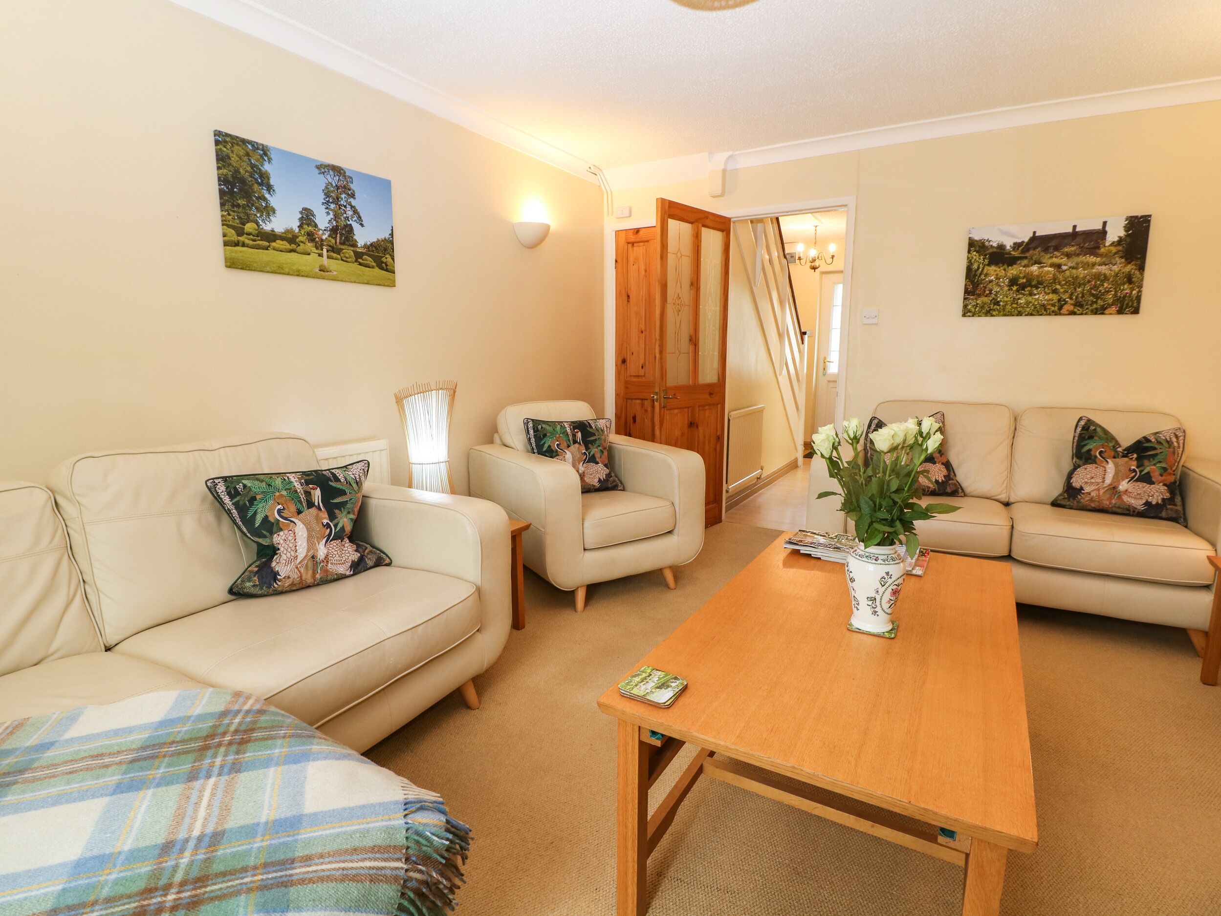 A cozy living room with two sofas, a coffee table, and a door leading to another room.