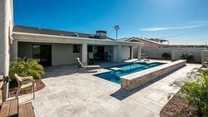 A modern house with a swimming pool, patio furniture, and a covered outdoor area. - Free Heated Pool, RV Garage, Hot Tub, Music, Views (Lake Havasu City)