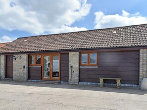 A building with a tiled roof, stone walls, and a wooden door. - 2 bedroom accommodation in Catsham, near Glastonbury (Catsham, near Glastonbury)