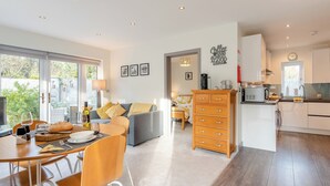 A modern living space with a dining area, kitchen, and a cozy seating area. - 1 bedroom accommodation in Boscombe, near Bournemouth (Boscombe, near Bournemouth)