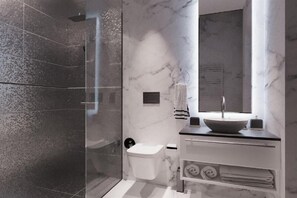 A modern bathroom with a glass shower enclosure, a white toilet, a vessel sink with a marble countertop, and a large mirror. - Henry Resort And Spa  (Golem)