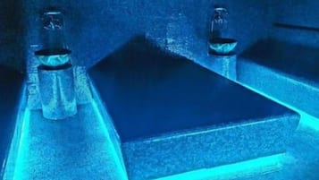 A close-up of a metallic surface with a blue light source.