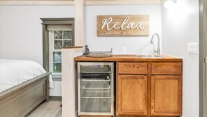 A compact kitchen with a built-in oven, a sink, and a wooden cabinet. - Contemporary, cozy,  hidden gem close to wineries (Buchanan)
