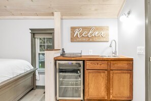 A compact kitchen with a built-in oven, a sink, and a wooden cabinet. - Contemporary, cozy, hidden gem close to wineries (Buchanan)