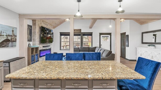 A spacious living area with a large kitchen island, a sofa, and a dining table. - Contemporary, cozy,  hidden gem close to wineries (Buchanan)