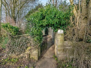 A stone archway with a sign reading "The Bungalow." - 2 bedroom accommodation in Codnor, near Ripley (Codnor, near Ripley)