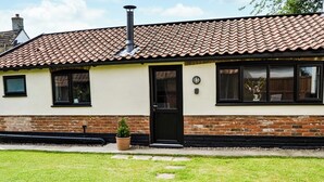 A two-story house with a tiled roof, a brick lower level, and a front door. - 1 bedroom accommodation in Great Hockham, near Thetford (Great Hockham, near Thetford)