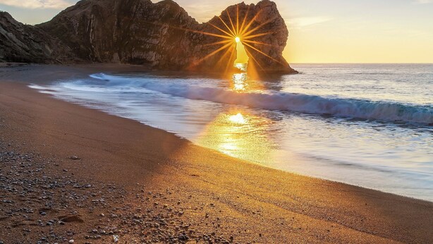 A beach with a large rock formation and waves. - 2 bedroom accommodation in Wool, near West Lulworth (Wool, near West Lulworth)