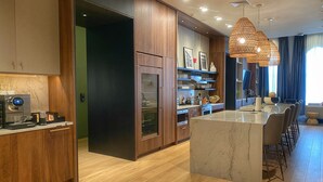 Una cocina moderna con armarios de madera, una isla integrada y un comedor con taburetes de bar.