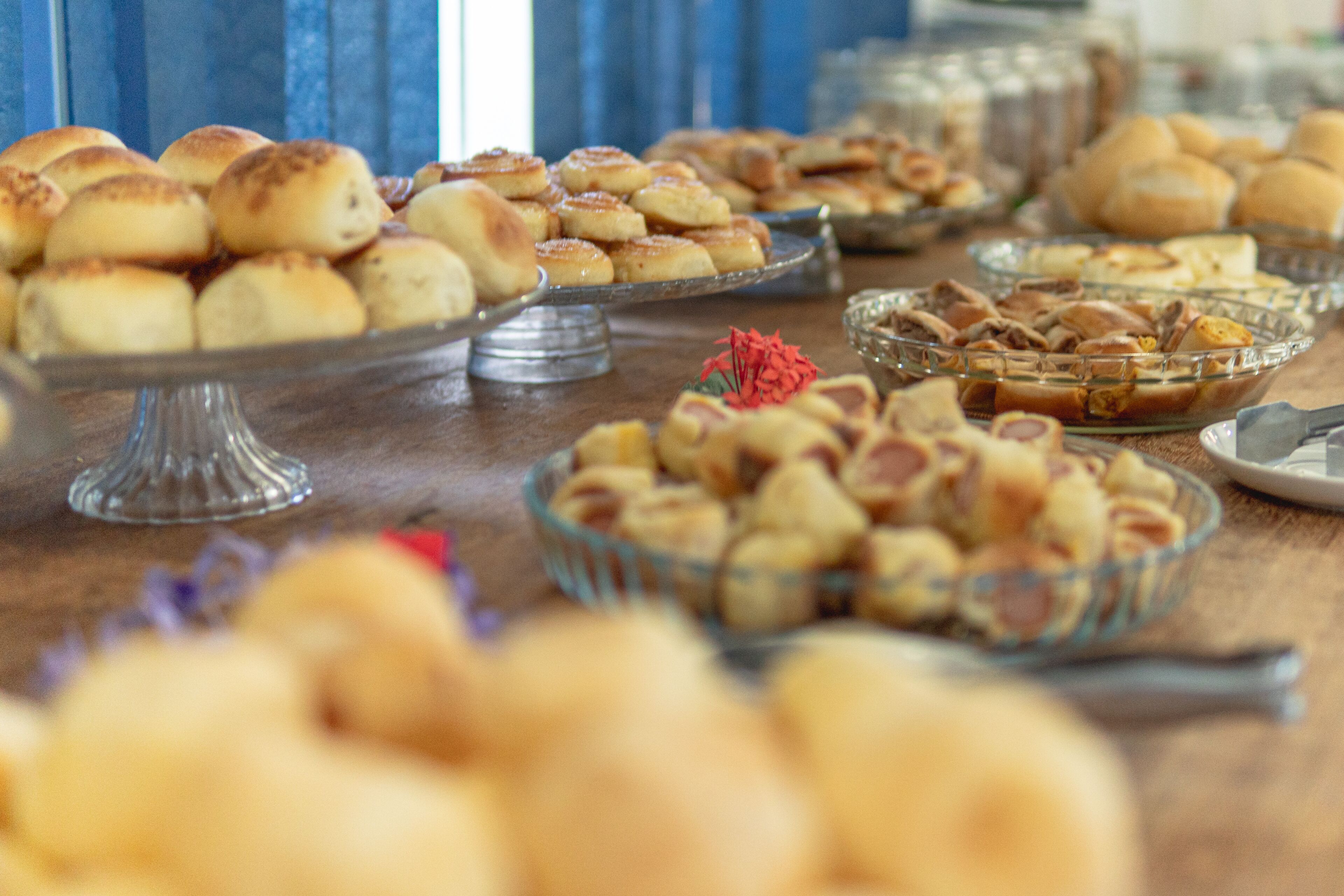 A buffet table with various baked goods and desserts.