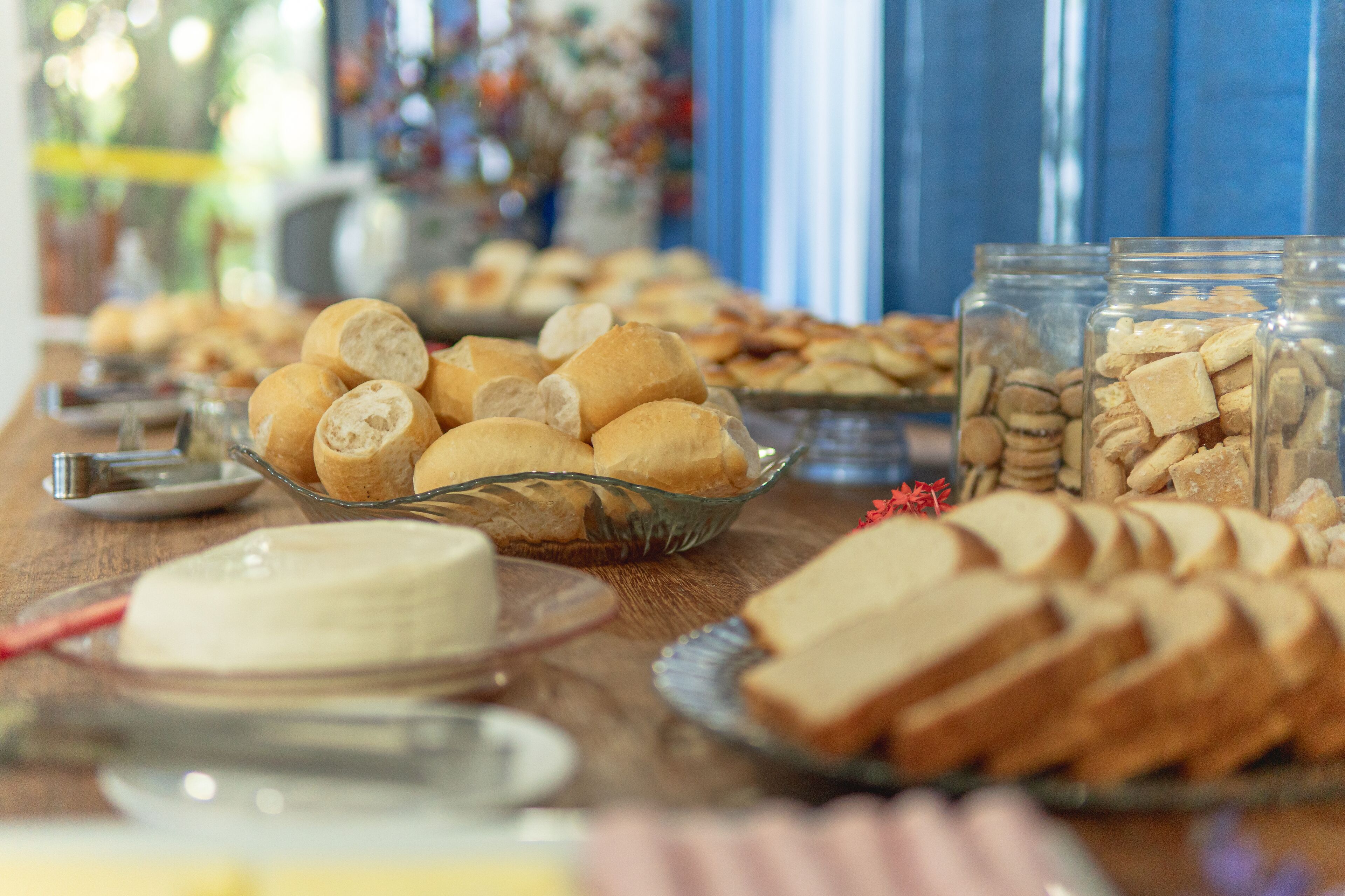 A buffet table with various breads and pastries.