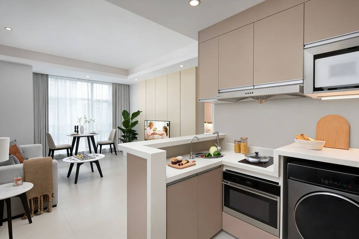 Una cocina moderna equipada con horno, lavavajillas y microondas. Cuenta con un comedor con mesa y sillas, y un amplio ventanal con cortinas.