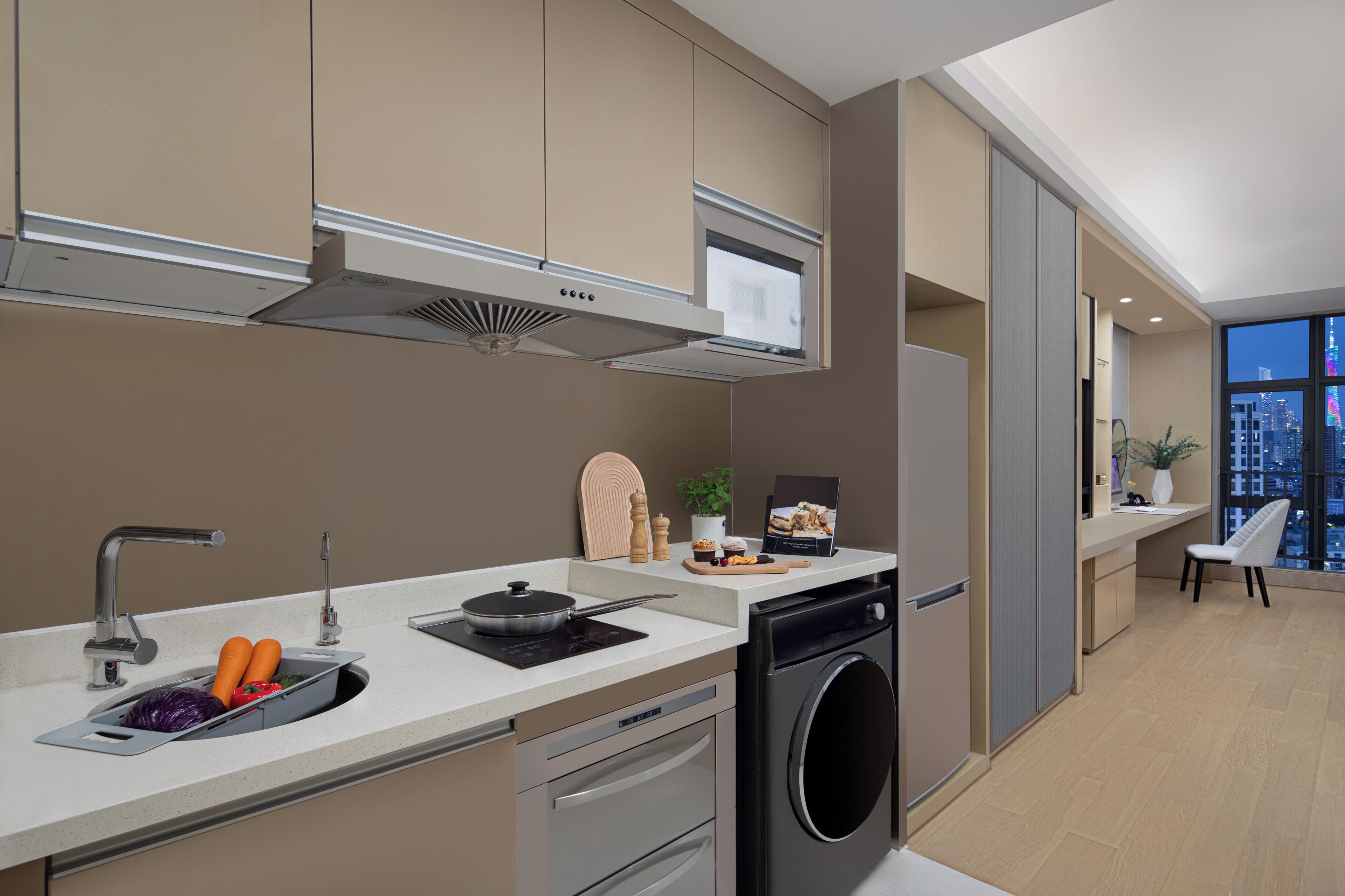 A modern kitchen with a built-in oven, a dishwasher, and a sink with a cutting board.